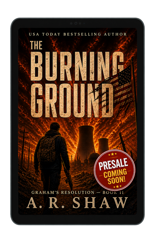 E-reader displaying The Burning Ground by A. R. Shaw, a post-apocalyptic survival novel featuring a lone man approaching a burning industrial landscape with a tattered American flag